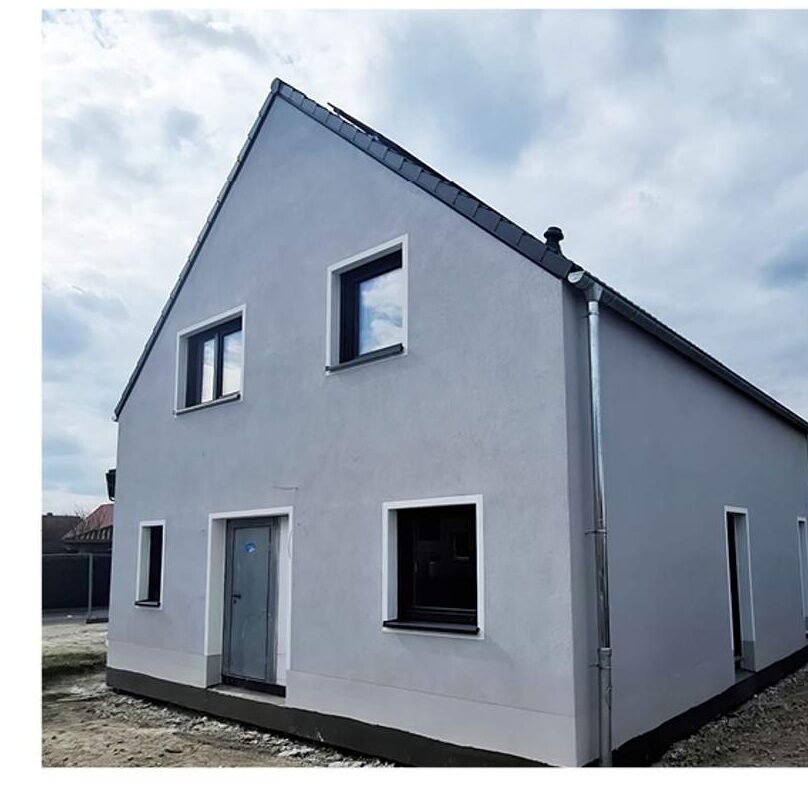 Modernes Satteldachhaus in Grau-Weiß-Optik mit hochwertiger Putzfassade.